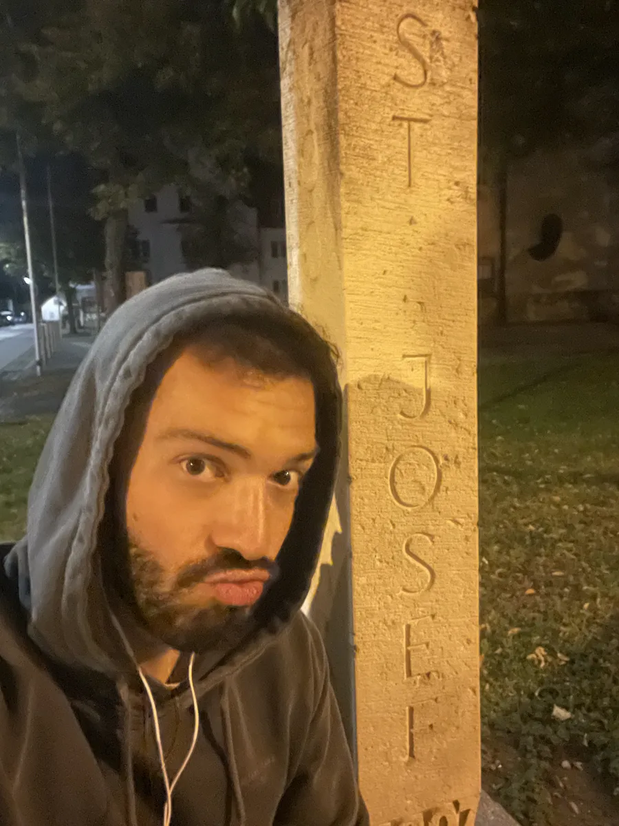 Josif next to a stone marker engraved "ST. JOSEF"